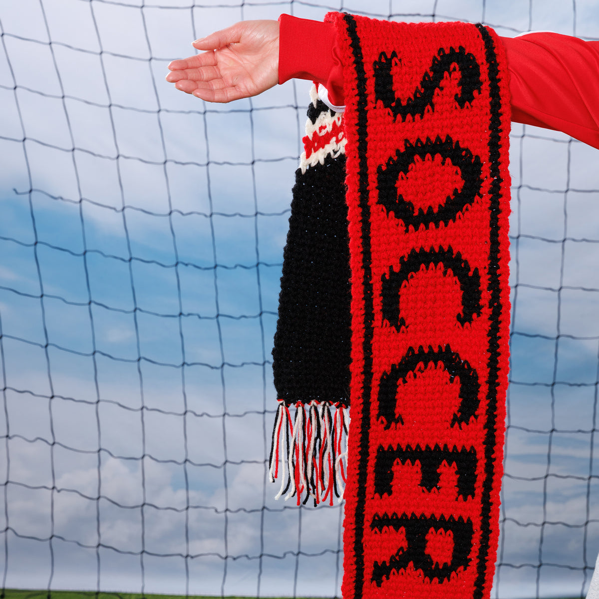 Team Pride Crochet Scarf made using Red Heart yarn in a styled lifestyle setting