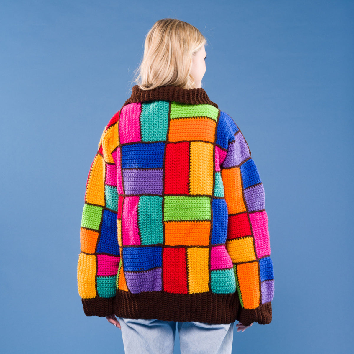 Parque Colors Crochet Cardigan made using Red Heart yarn in a styled lifestyle setting