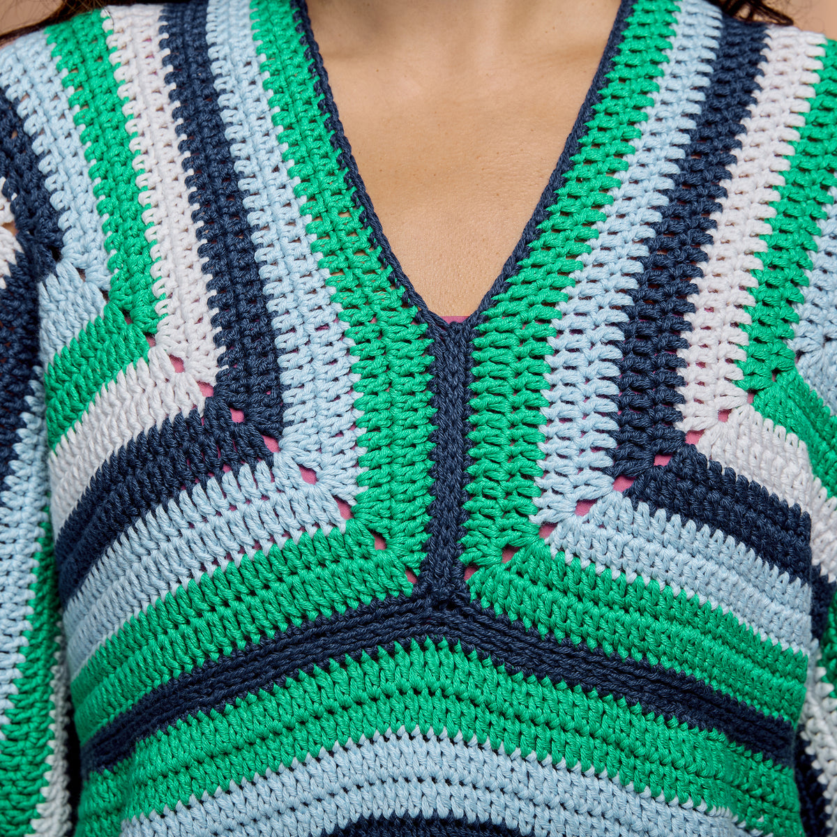 Striped Crochet Tunic made using Red Heart yarn in a styled lifestyle setting