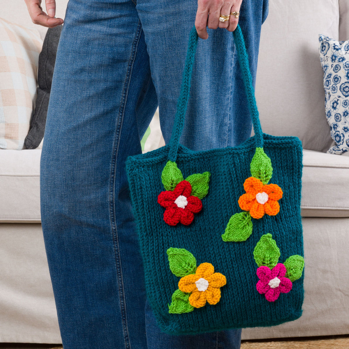 Knit Floral Tote made using Red Heart yarn in a styled lifestyle setting