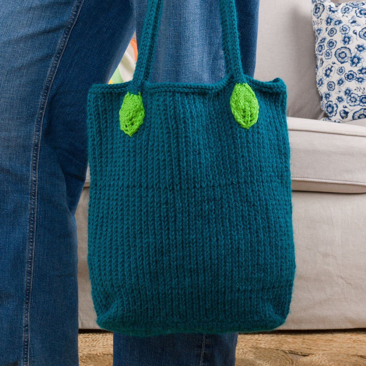Knit Floral Tote made using Red Heart yarn in a styled lifestyle setting