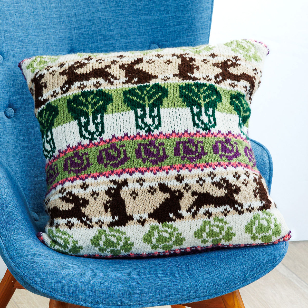 Cabbage Garden Knit Pillow made using Red Heart yarn in a styled lifestyle setting