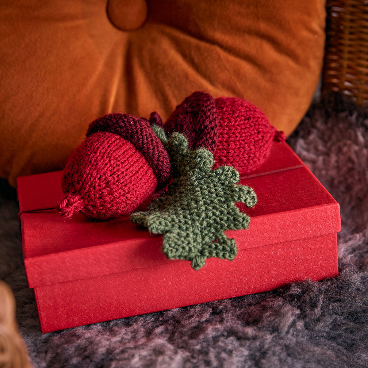 Acorn & Pinecone Knit Ornaments made using Red Heart yarn in a styled lifestyle setting