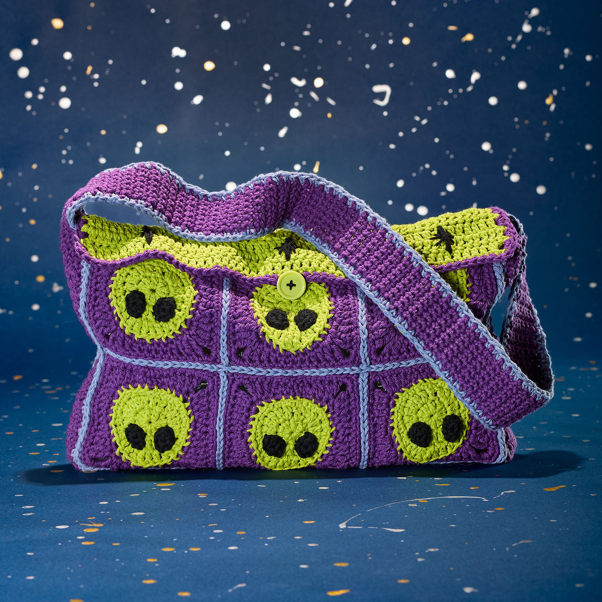 Crochet Extraterrestrial Messenger Bag made using Lily yarn in a styled lifestyle setting