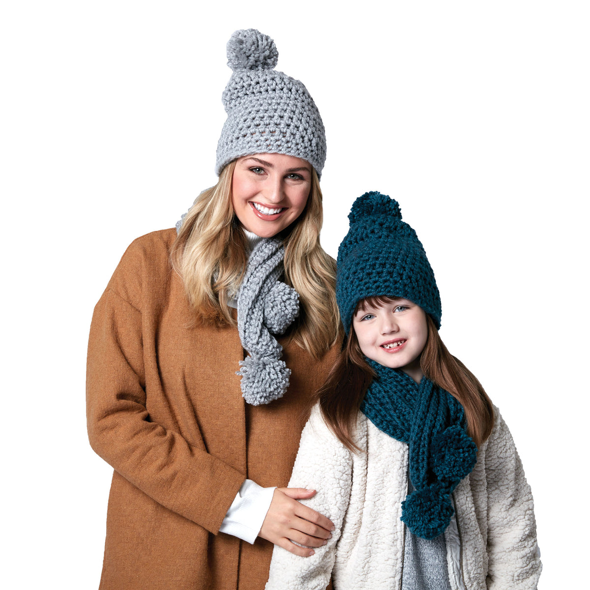 Woman and child wearing crochet hats and scarves on a white background