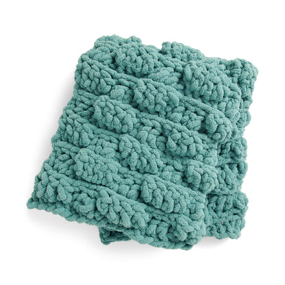 Bernat Puff Piece Crochet Lap Blanket Puff Piece Crochet Lap Blanket made using Bernat yarn on a white background