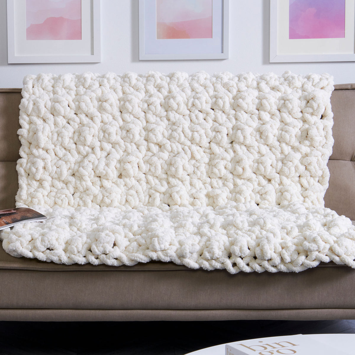 Serious Snuggles Crochet Blanket made using Bernat yarn on a white background