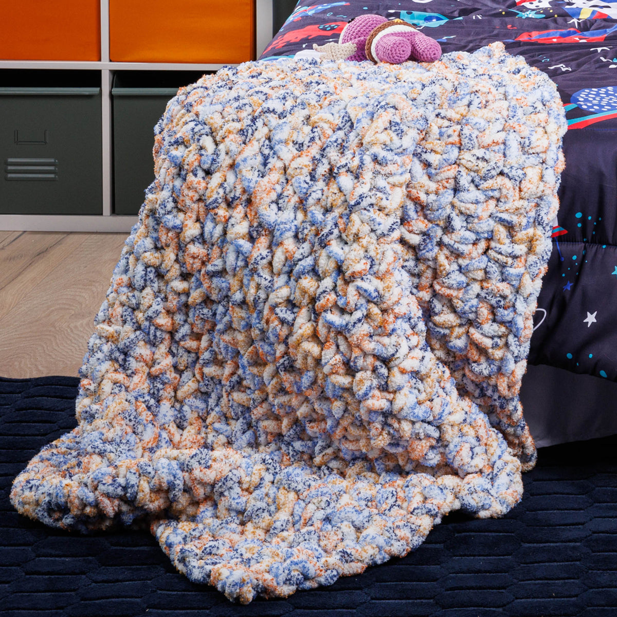 Big textured crochet blanket made using Bernat yarn.