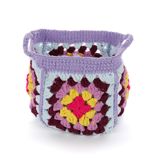Crochet Granny'S Stash Basket made using Bernat yarn in a styled lifestyle setting