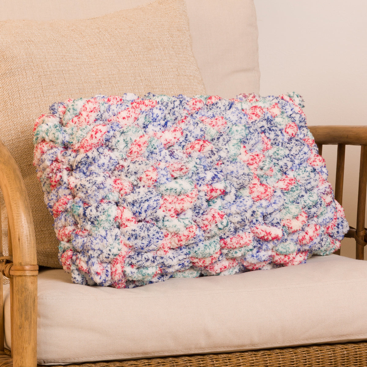 Quick Crochet Lumbar Pillow made using Bernat yarn in a styled lifestyle setting