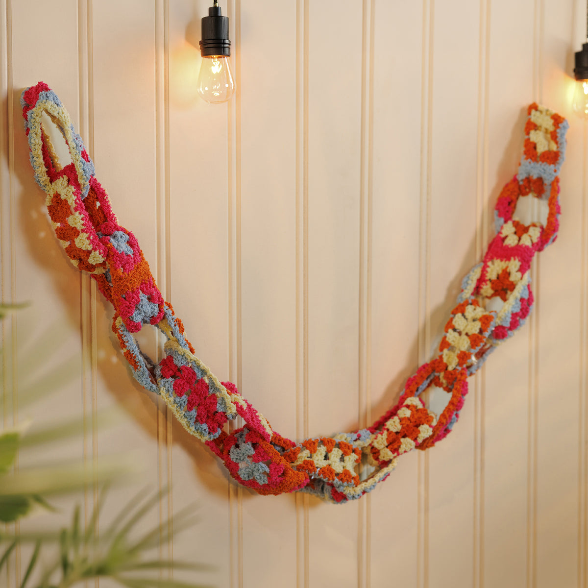 Crochet Granny Chain Garland made using Bernat yarn in a styled lifestyle setting