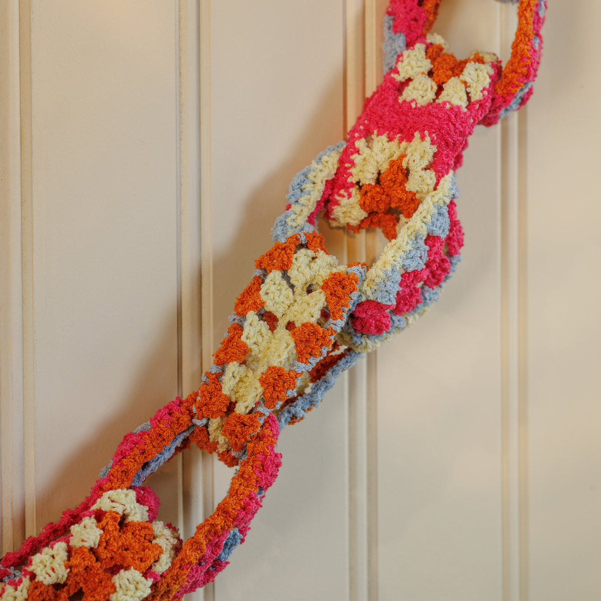 Crochet Granny Chain Garland made using Bernat yarn in a styled lifestyle setting