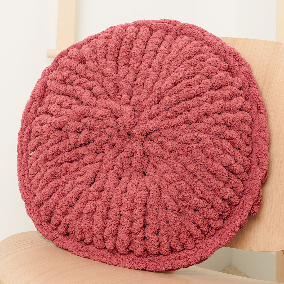 Roundabout Table Knit Pillow made using Bernat yarn in a styled lifestyle setting