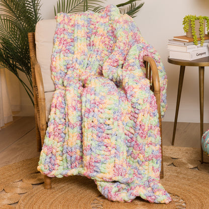 Bernat Simple Ribbing Table Knit Blanket Simple Ribbing Table Knit Blanket made using Bernat yarn in a styled lifestyle setting