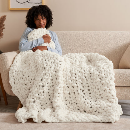 Bernat Cozy Does It Seed Stitch Knit Blanket Cozy Does It Seed Stitch Knit Blanket made using Bernat yarn in a styled lifestyle setting