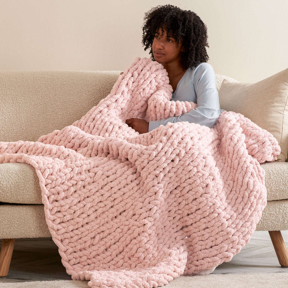 Nap Trapped Stocking Stitch Knit Blanket made using Bernat yarn in a styled lifestyle setting