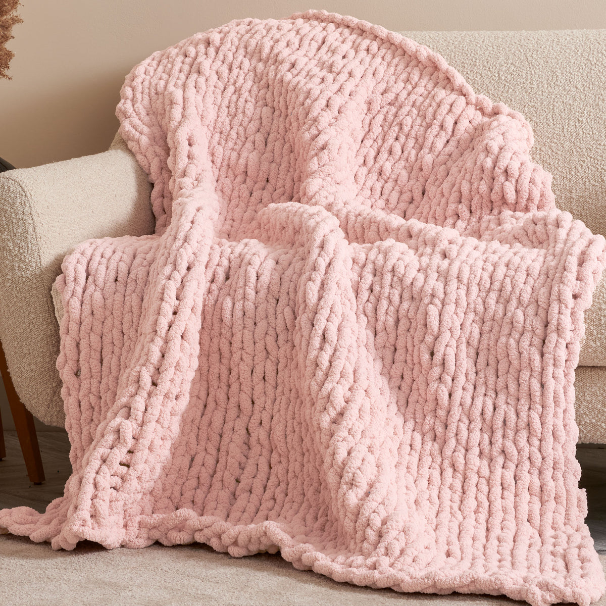 Nap Trapped Stocking Stitch Knit Blanket made using Bernat yarn in a styled lifestyle setting