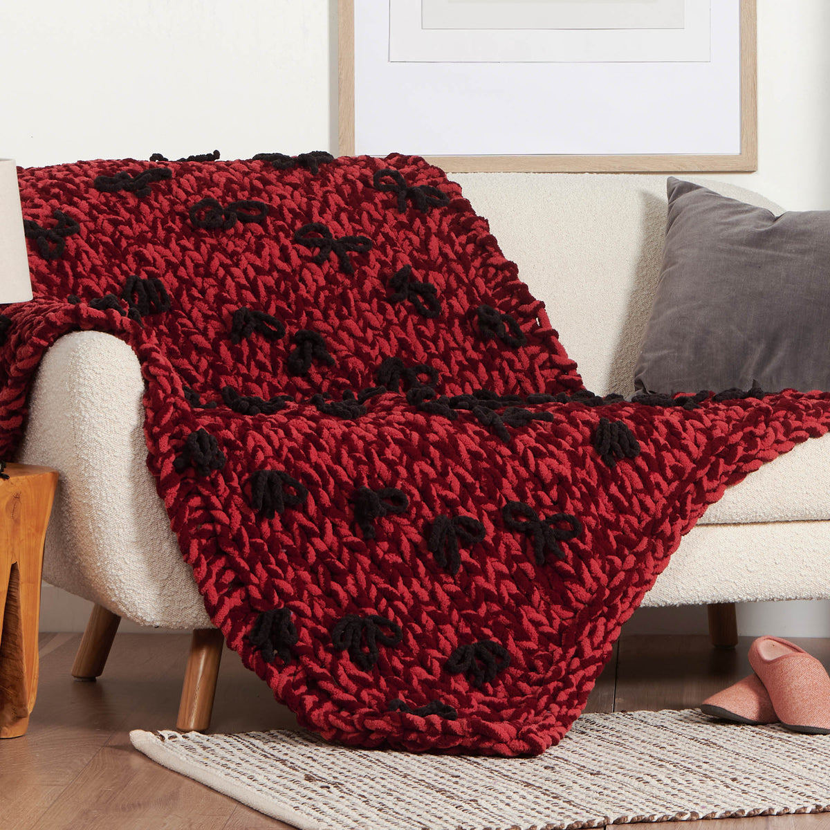 Put A Bow On It Table Knit Blanket made using Bernat yarn in a styled lifestyle setting