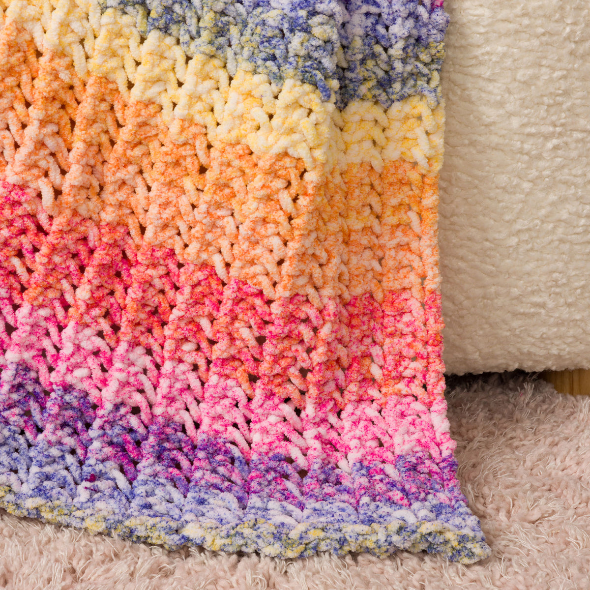 Eyelet Ridge Knit Blanket made using Bernat yarn in a styled lifestyle setting