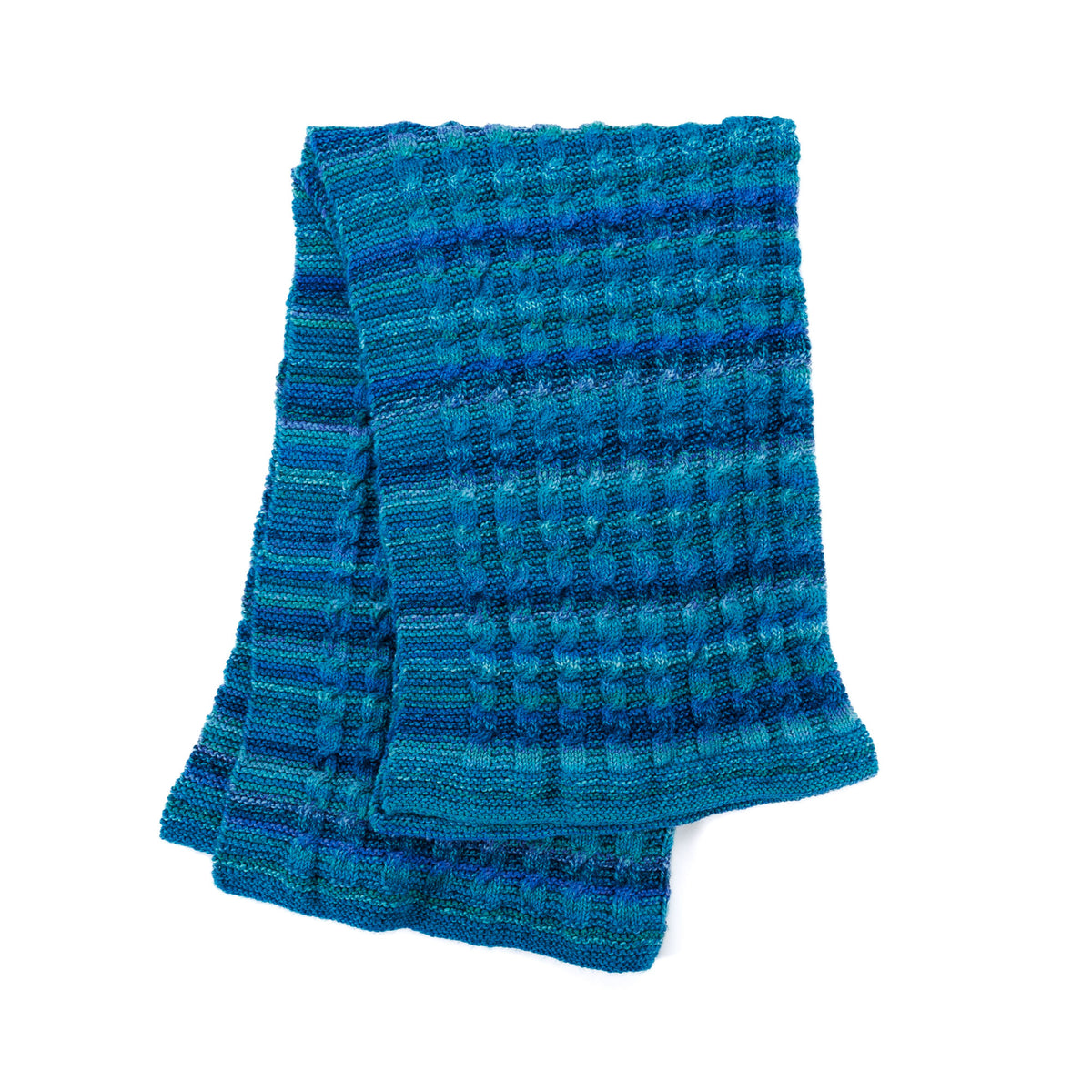 Knit Classic Cables Throw made using Bernat yarn in a styled lifestyle setting