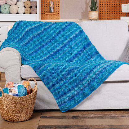 Bernat Knit Classic Cables Throw Knit Classic Cables Throw made using Bernat yarn in a styled lifestyle setting