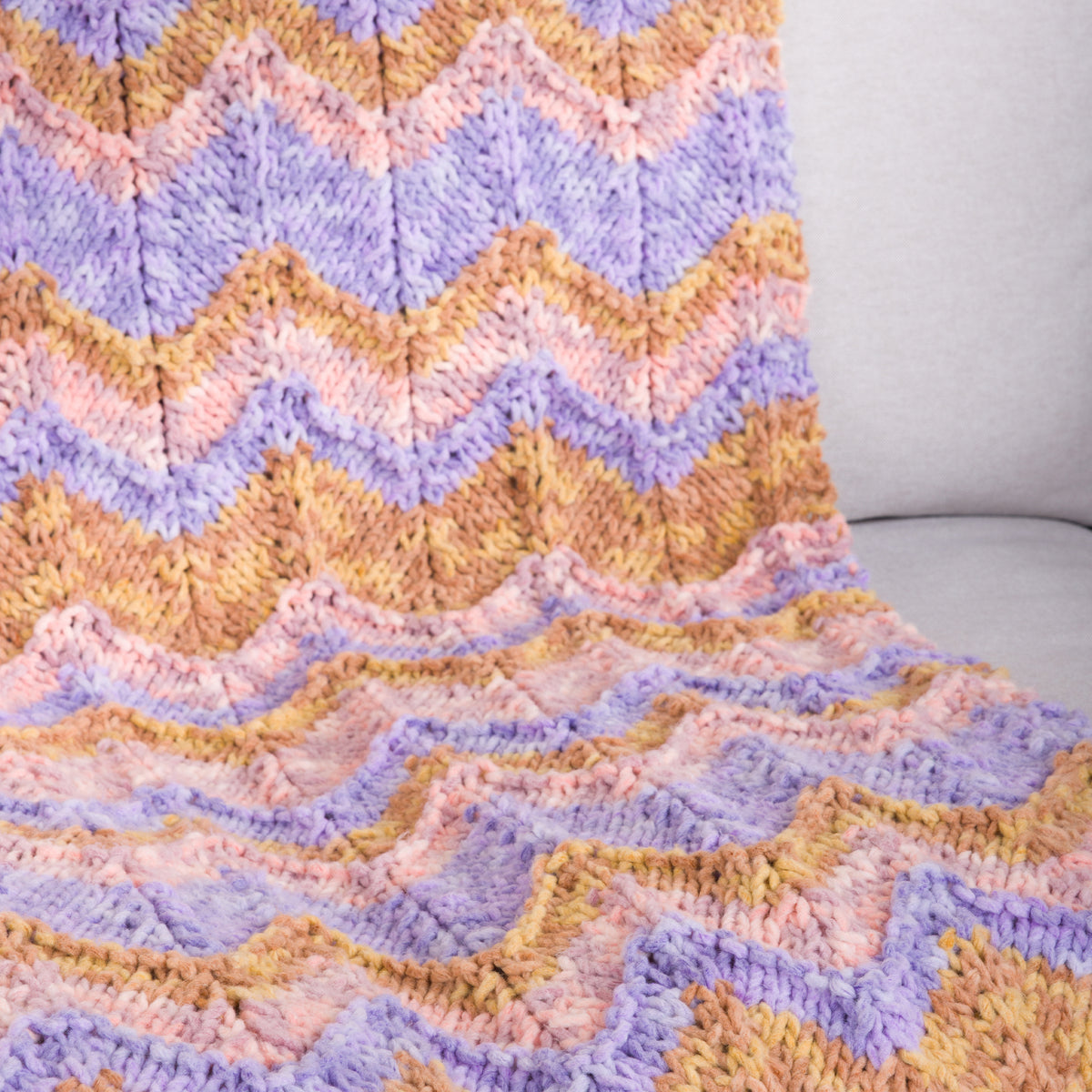 Enchanted Drift Knit Chevron Blanket made using Bernat yarn