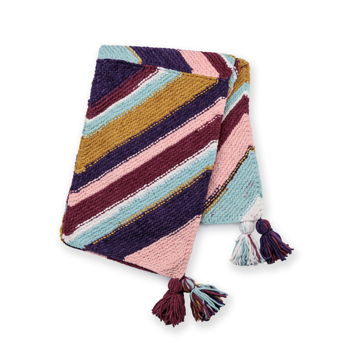 Quarter Stripes Knit Blanket made using Bernat yarn in a styled lifestyle setting