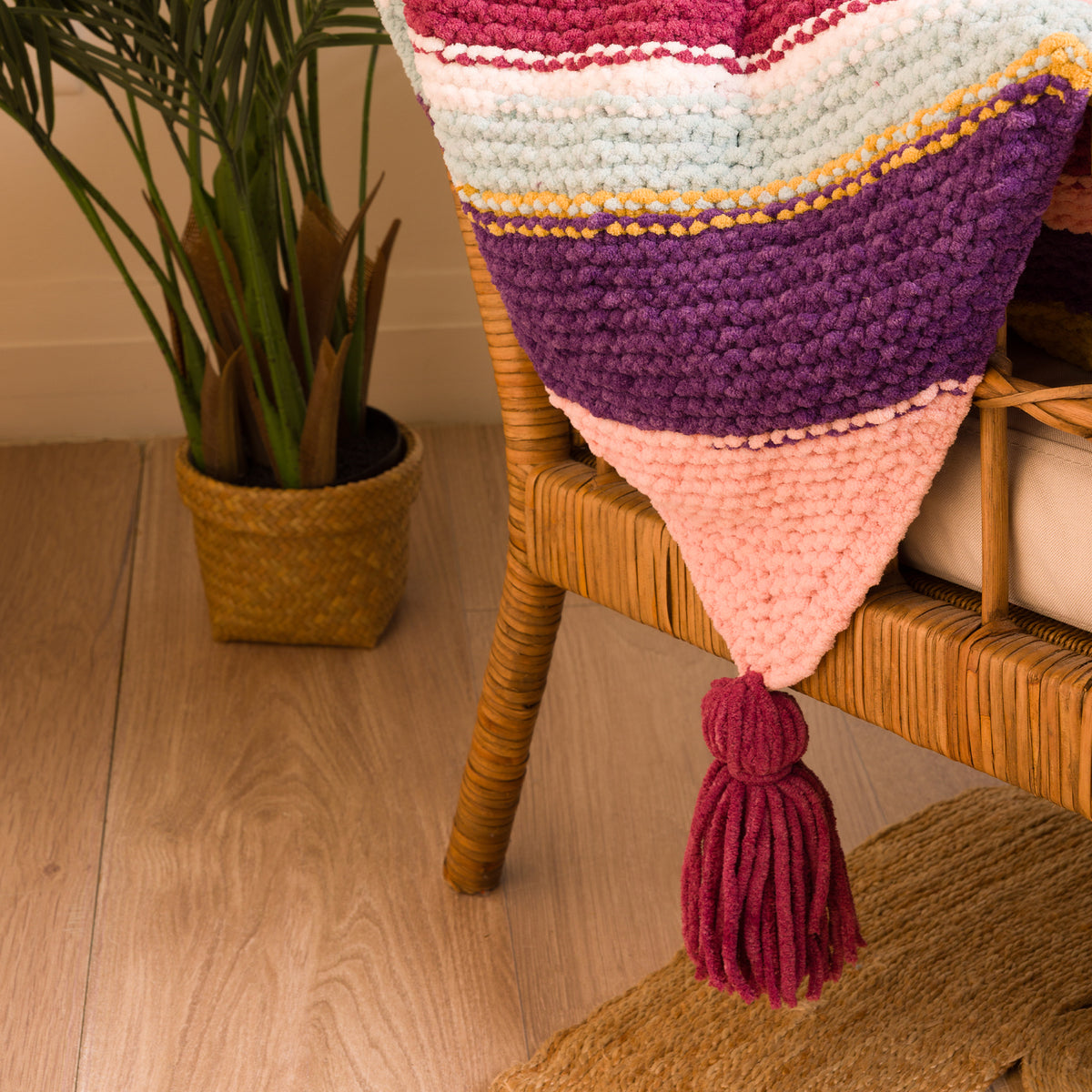 Quarter Stripes Knit Blanket made using Bernat yarn in a styled lifestyle setting
