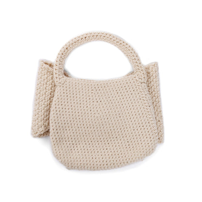 Caron Crochet Bow Bag Crochet Bow Bag made using Caron yarn in a styled lifestyle setting