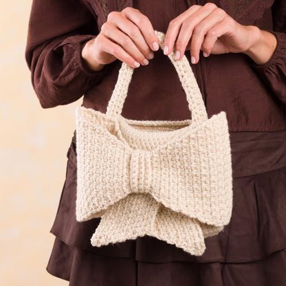 Caron Crochet Bow Bag Crochet Bow Bag made using Caron yarn in a styled lifestyle setting