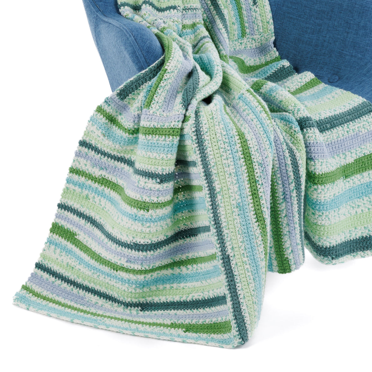 Crochet Every Way Blanket made using Caron yarn in a styled lifestyle setting