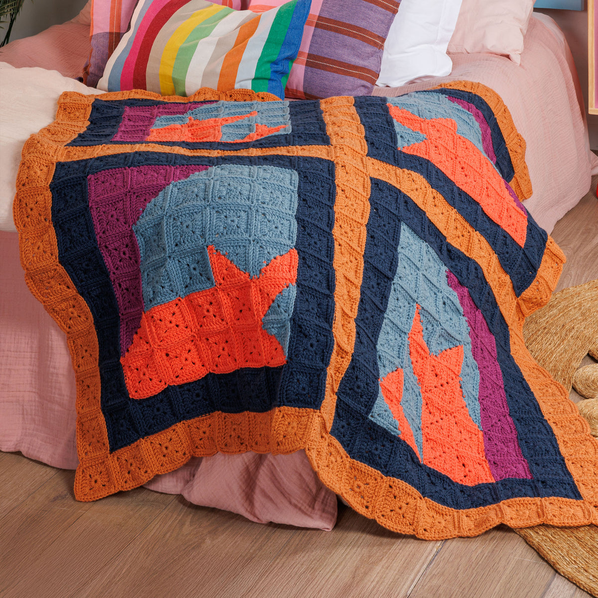 Crochet Feline Framework Quilt made using Caron yarn in a styled lifestyle setting