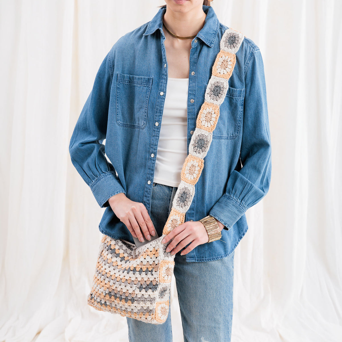 Crochet Tie Top Tote made using Caron yarn in a styled lifestyle setting