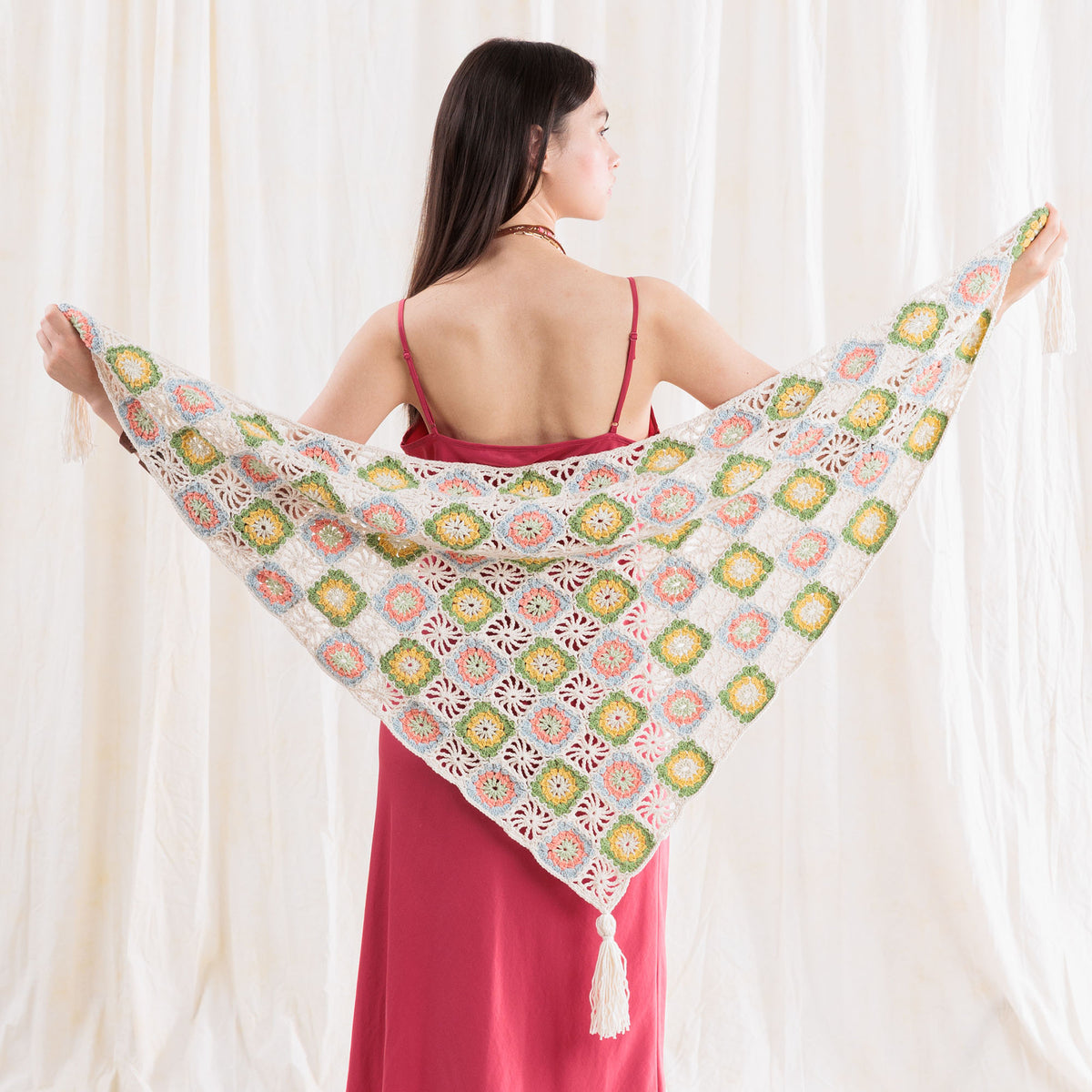 Summer Mode Crochet Triangle Shawl With Tassels made using Caron yarn in a styled lifestyle setting