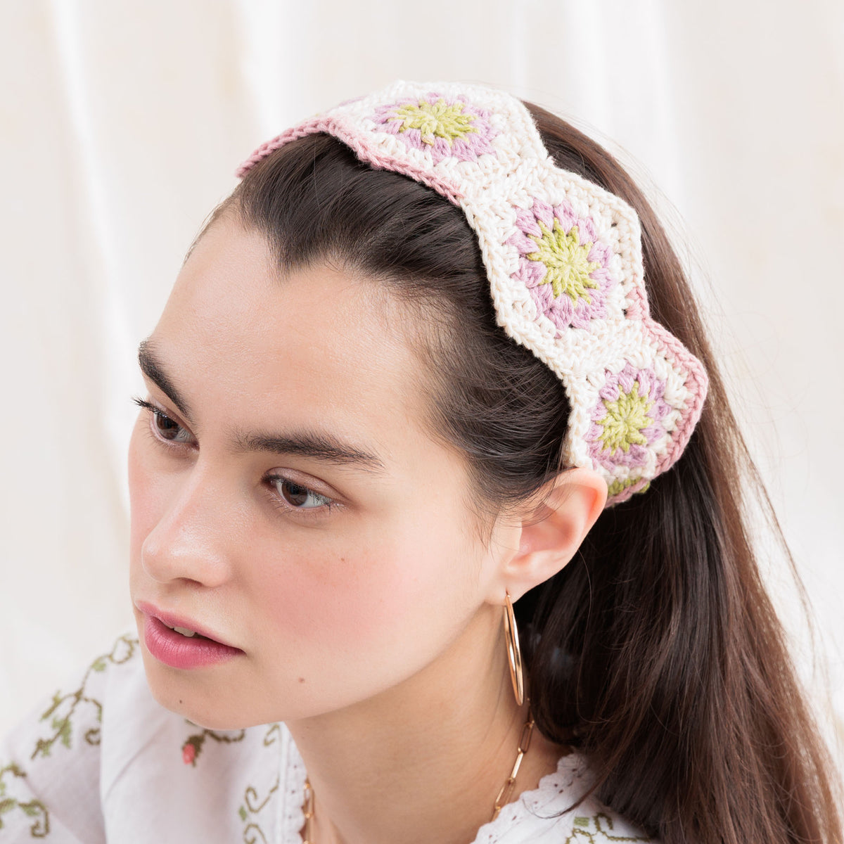 Summer Mode Crochet Headband made using Caron yarn in a styled lifestyle setting