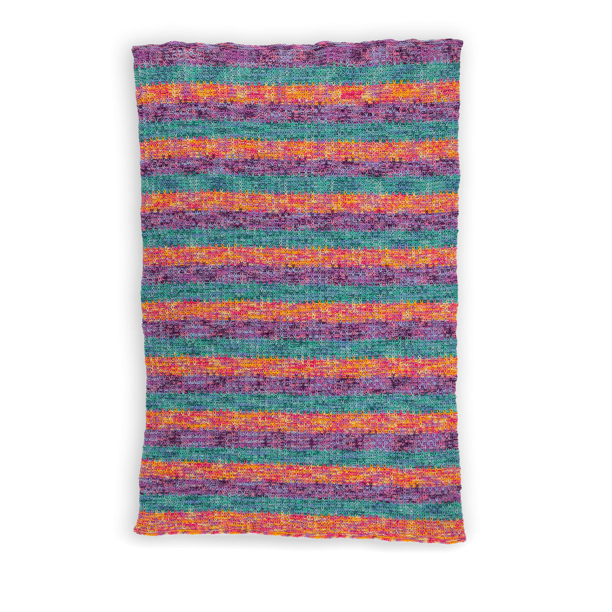 Slipstream Knit Blanket made using Caron yarn in a styled lifestyle setting