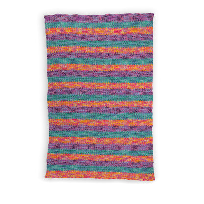 Caron Slipstream Knit Blanket Slipstream Knit Blanket made using Caron yarn in a styled lifestyle setting