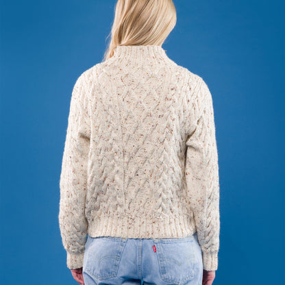 Caron Floral Medallions Knit Pullover Floral Medallions Knit Pullover made using Caron yarn in a styled lifestyle setting