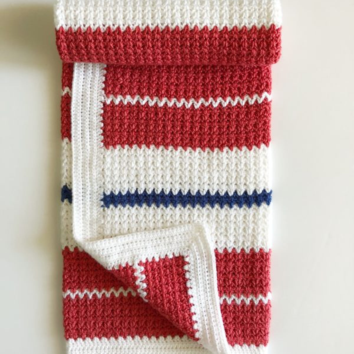 Americana V-Stitch Crochet Blanket made using Modern yarn in a styled lifestyle setting