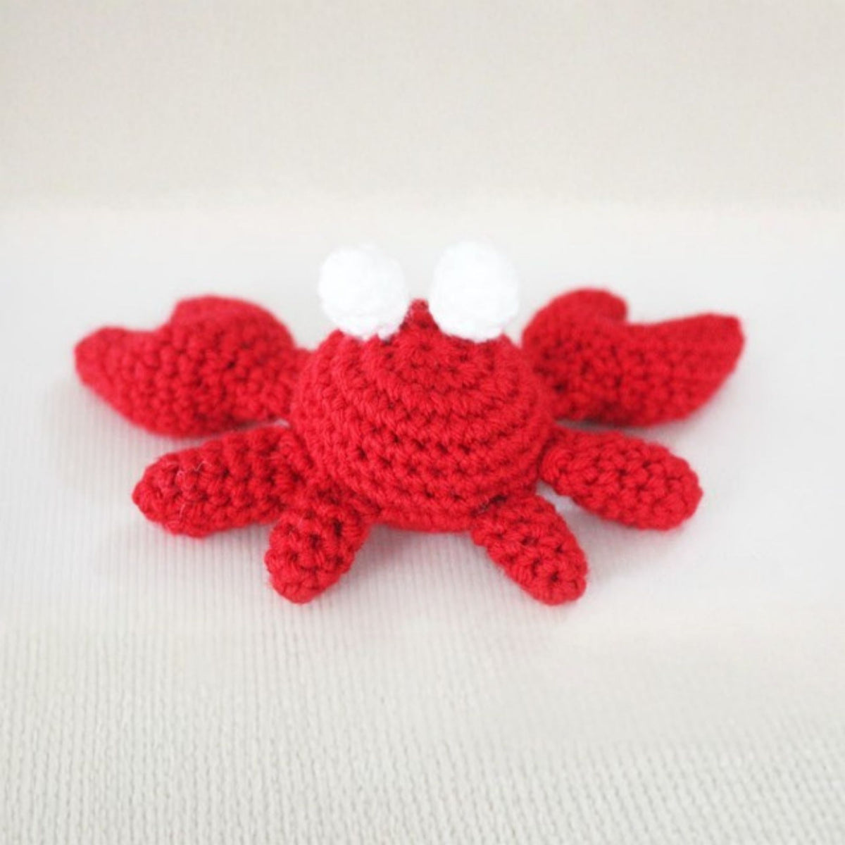 Feeling Crabby Crochet Amigurumi made using Red Heart yarn in a styled lifestyle setting