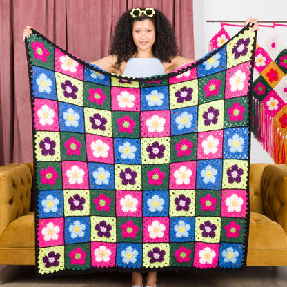 Red Heart Crochet Flower Bed Blanket A crocheted blanket with a colorful floral pattern made using Red Heart All in One Flower Power yarn, Version 1