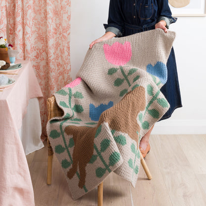 Red Heart Leaping into Spring Crochet Blanket Leaping Into Spring Crochet Blanket made using Red Heart yarn in a styled lifestyle setting