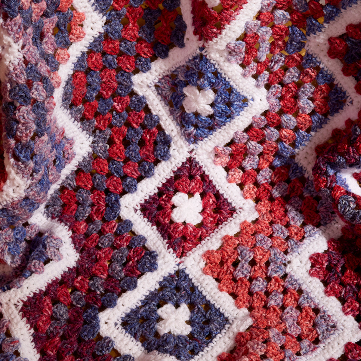 Crochet Firework Throw made using Red Heart yarn in a styled lifestyle setting