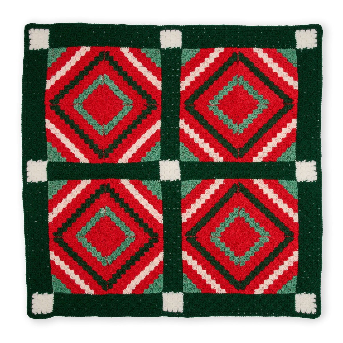 Crochet Quilted Classic Christmas Blanket made using Red Heart yarn on a white background