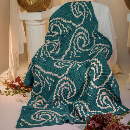 Red Heart It's Just a Wave Crochet Blanket It'S Just A Wave Crochet Blanket made using Red Heart yarn in a styled lifestyle setting