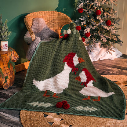 Red Heart Holiday Geese Crochet Blanket Holiday Geese Crochet Blanket made using Red Heart yarn in a styled lifestyle setting