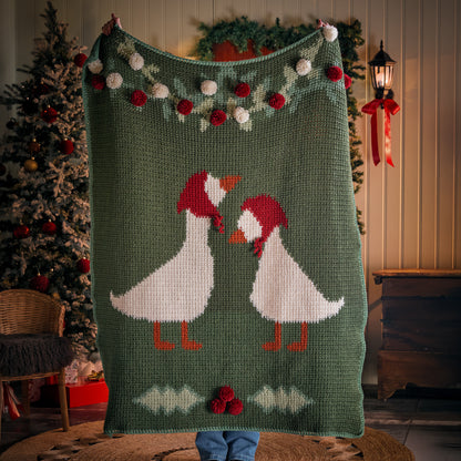 Red Heart Holiday Geese Crochet Blanket Holiday Geese Crochet Blanket made using Red Heart yarn in a styled lifestyle setting