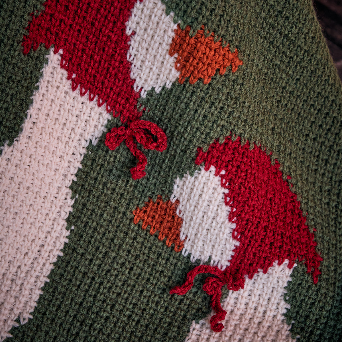 Holiday Geese Crochet Blanket made using Red Heart yarn in a styled lifestyle setting
