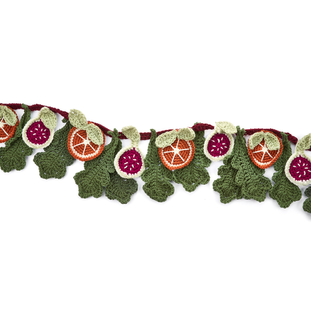 Festive Abundance Crochet Garland made using Red Heart yarn in a styled lifestyle setting