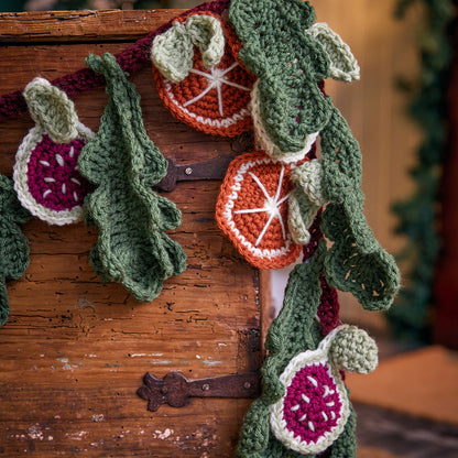 Red Heart Festive Abundance Crochet Garland Festive Abundance Crochet Garland made using Red Heart yarn in a styled lifestyle setting